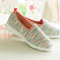 A pair of multi coloured canvas shoes on a table